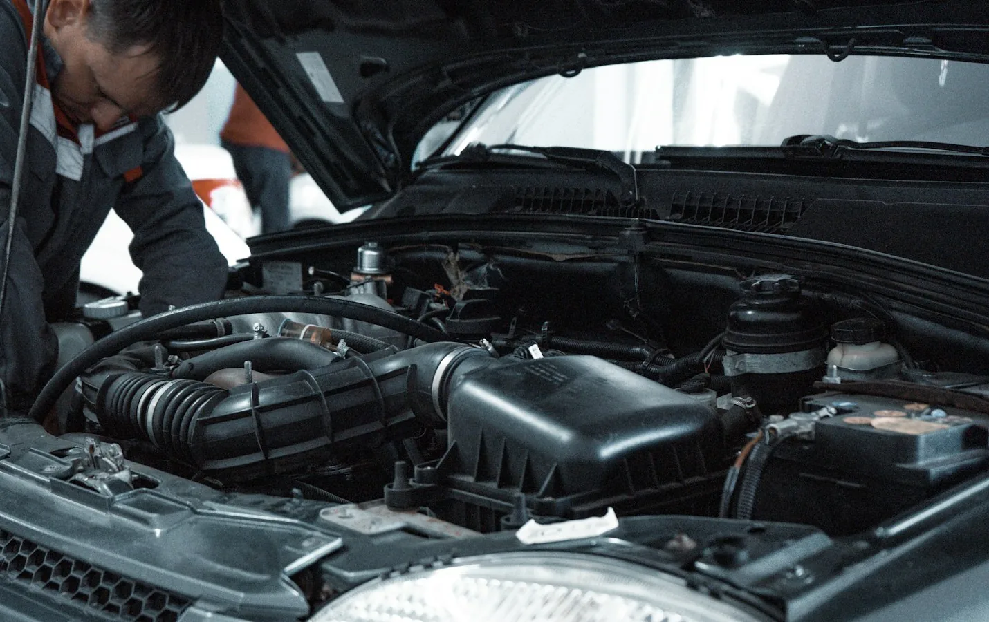 Mechanic working under the hood of a car