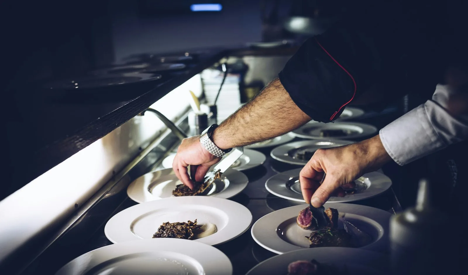 Chef plating dishes in a restaurant kitchen